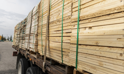 Stacked lumber on a flat bed truck.