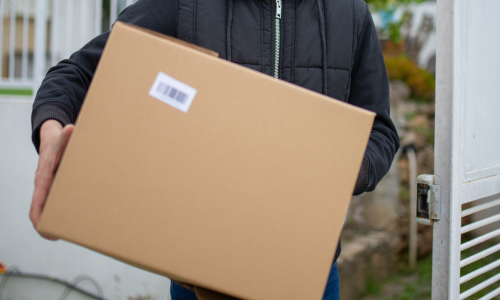 A large cardboard box being carried.